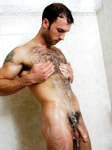 Hairy guy with soap all over his body